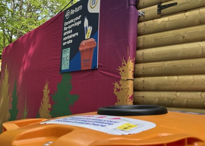 An orange Re-turn bin located at Riverfest 2025 used to collect donated empty drink containers funding the Return for Children charity partner.