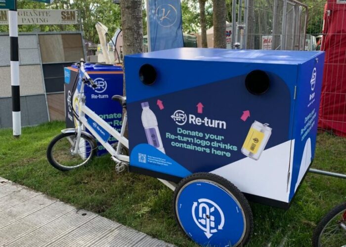 An orange Re-turn bin located at Riverfest 2025 used to collect donated empty drink containers funding the Return for Children charity partner.